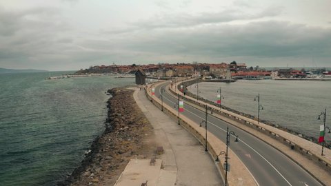 Aerial drone fly over windmill in old town Nessebar Bulgaria. Beautiful Landscape view of small town into the Black Sea at winter cloudy contidions.
