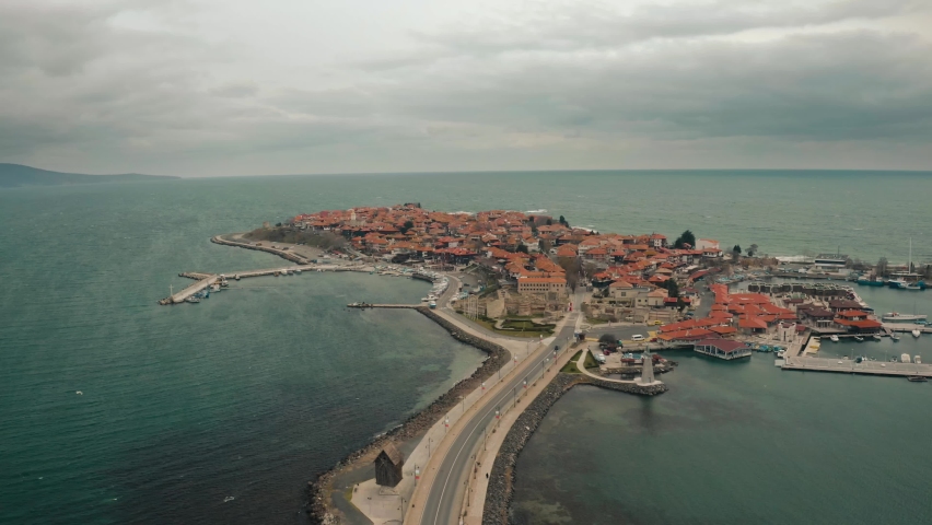 Aerial drone fly over old town Nessebar Bulgaria. Beautiful Landscape view of small town into the sea at winter cloudy contidions.