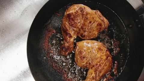 Top View of Two Flavorful Crispy Pan Roasting Chicken Leg Quarters with Backs