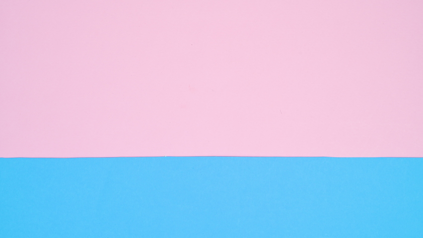 6k Rabbit ears appear on pastel pink and blue background. Easter copy space stop motion