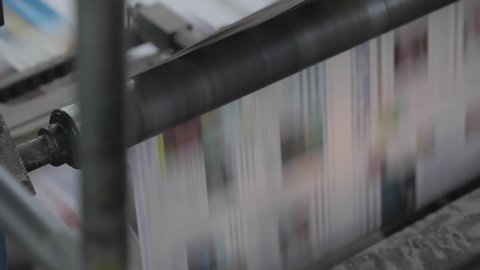 printing of paper newspapers in motion passing through different machines
