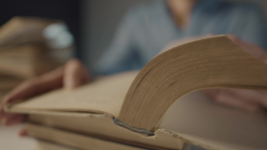 book close-up flipping pages. man reading a book in the library. education bookstore concept. university book turn pages slow motion video. bookstore close-up lifestyle hands men reading a book Royalty-Free Stock Footage #1088054363