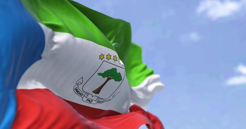 Detail of the national flag of Equatorial Guinea waving in the wind on a clear day. Equatorial Guinea is a country on the west coast of Central Africa. Selective focus. Seamless looping in slow motion