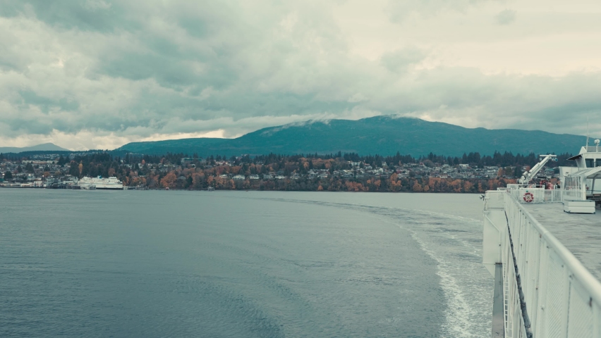 Large passenger ferry departs from coastal community