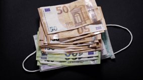 Medical gauntlet trown down on pile of euro cash money. Concept of challenging inflation, stagflation after covid-19 pandemic and Russia Ukraine war - Powered by Shutterstock - Get 15% off with code: PIKWIZARD15