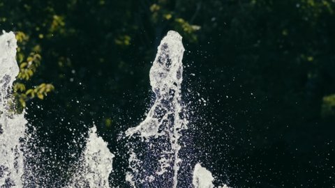 Water jets from the fountain. waterjet city fountain. water pressure. Hot summer in the city. Fountain splashes close up. dancing fountain. Splashes shining in the sun . slow motion. 4K