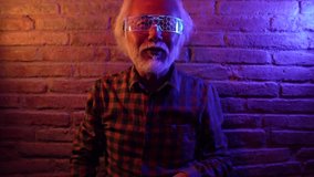 Asian elderly man, with virtual reality headset, doing futuristic martial arts combat - metaverse concept - - Powered by Shutterstock - Get 15% off with code: PIKWIZARD15