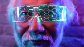 portrait of gray haired elderly asian man, with futuristic glasses, neon lights- Metaverse VR - Powered by Shutterstock - Get 15% off with code: PIKWIZARD15
