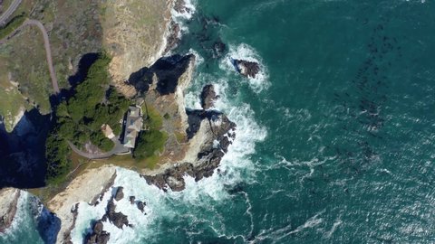 Aerial view of a house on the cliff and seascape. House on a cliff facing the sea. Aerial drone shot of beautiful houses in top of a cliff. 