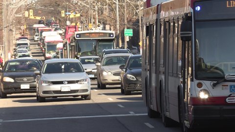 Toronto, Ontario, Canada March 2022 Public transit buses stuck in massive gridlock car traffic jam on city streets
