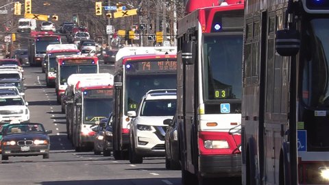Toronto, Ontario, Canada March 2022 Public transit buses stuck in massive gridlock car traffic jam on city streets