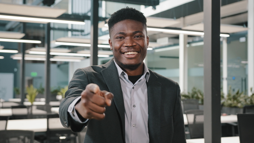 Multiracial man American male businessman investor financial specialist of large company standing with smile pointing index finger at camera with hey you gestures choosing making choice in office hall | Shutterstock HD Video #1088062263