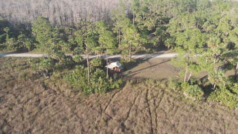 everglades , fl , United States - 03 04 2022: volkswagen vanagon westfalia campervan camping campground everglades forest grass vanlife aerial drone orbit