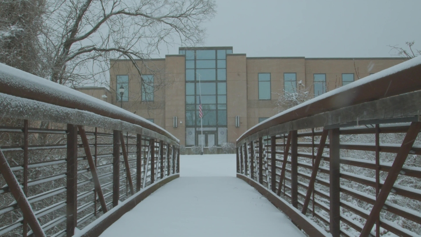 Boulder , Colorado United States - 08 21 2019: Pedestrian going through a bridge in slow motion while snowfall appearing.