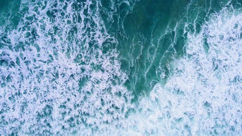 Nature video 4K Aerial view of drone. Scene of top view beach and seawater on sandy beach in summer. Dark blue sea wave texture movement. Nature and travel concept.