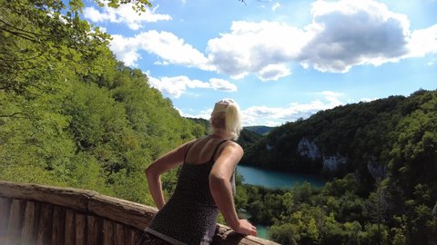 woman by panorama on Korana river and Milanovac lakes. Plitvice Lakes National Park in Croatia. Natural park of lakes and falls in Lika region. UNESCO World Heritage of Croatia named Plitvicka Jezera