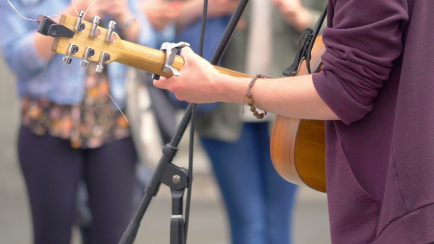 Street musician playing guitar in slow motion 180fps