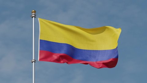 Close smooth shot of Colombian flag in the wind, Strong wind moving Colombian flag in summer time in Medellin. Flag of Colombia waving at wind against beautiful blue sky. Looped animation. Flag pole.