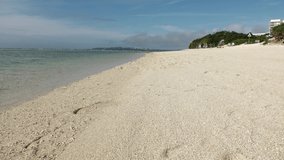 OKINAWA, JAPAN - AUG 2021 : View of Sesoko beach(Ocean or sea) at Sesoko island in daytime. Clear blue sunny sky and clouds. Summer holiday, vacation and resort concept video.