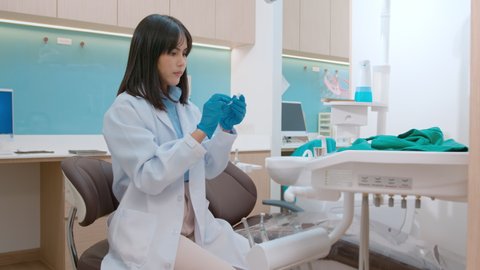 Young female dentist holding Invisalign in dental clinic, teeth check-up and Healthy teeth concept

