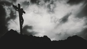 Jesus Christ crucified at Calvary hill outside ancient Jerusalem. The Crucifixion of Christ with Stormy clouds time lapse. Vintage film look, 4k video