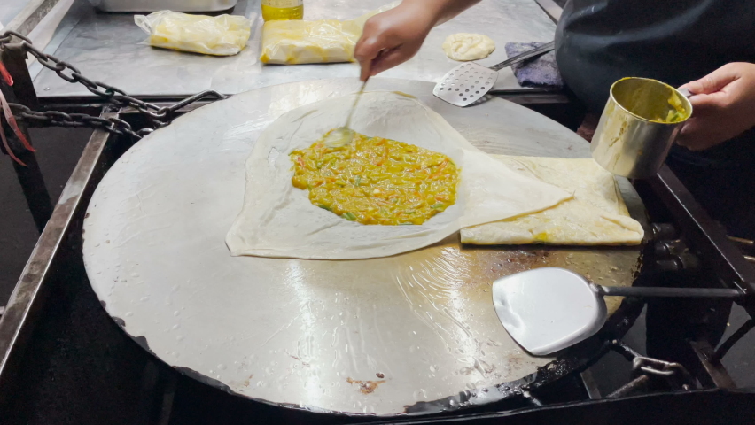 Roti fried on pan - mix egg, vegetable and chicken with roti dough ...