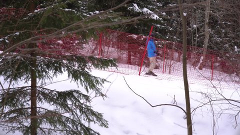 Skier slides down the slope in the mountains, ski center, winter sports