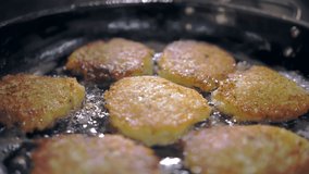 potato latkes. potato patty. cooking. Potato cakes, zrazy. buffet restaurant kitchen. close-up. The cook is flipping crispy potato latkes, frying in sizzling oil. - Powered by Shutterstock - Get 15% off with code: PIKWIZARD15