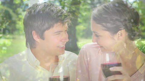 Animation of lights over happy caucasian couple having picnic with wine on sunny day. wine business, celebration and spending time together concept digitally generated video.