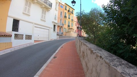 Monaco, October 6, 2021: DOLLY SLOW MOTION SHOT - The Rue des Remparts street in old district Monaco-Ville with historic buildings near the Prince's Palace of Monaco.