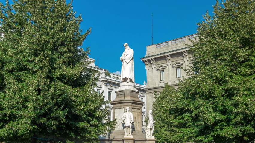 Monument to Leonardo da Vinci in Piazza della Scala (meaning La Scala square) timelapse hyperlapse. It designed by sculptor Pietro Magni in 1872 in Milan, Italy. Blue sky at summer day. Green trees