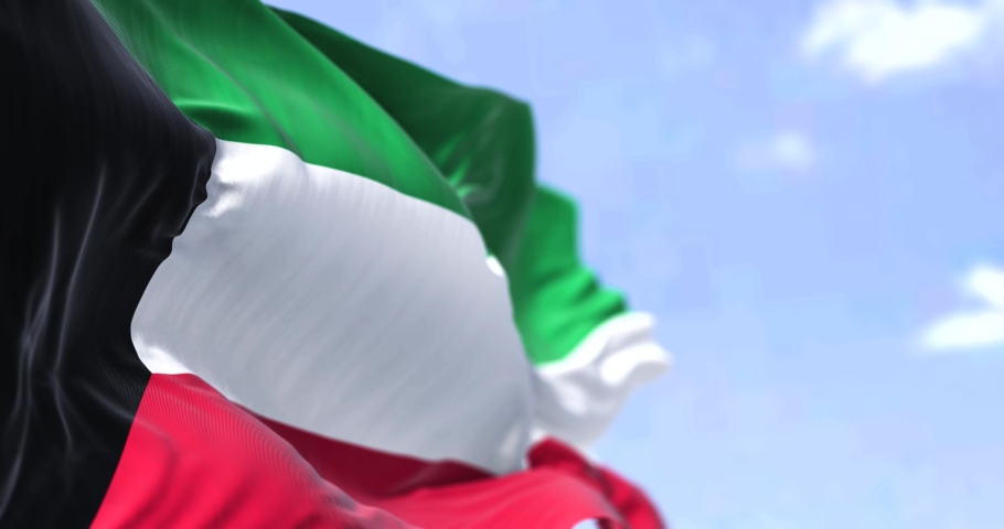 Detail of the national flag of Kuwait waving in the wind on a clear day. Kuwait is a country in Western Asia. Selective focus. Seamless loop in slow motion Royalty-Free Stock Footage #1088091555