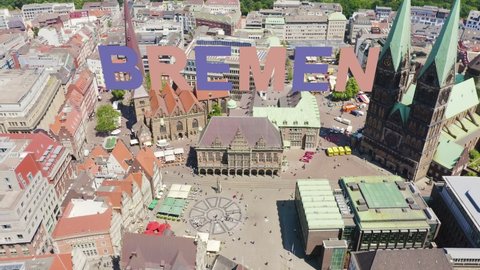 Inscription on video. Bremen, Germany. Bremen Market Square ( Bremer Marktplatz ), Bremen Cathedral ( St. Petri Dom Bremen ). View in flight. Multicolored text appears and disappears, Aerial View, Po
