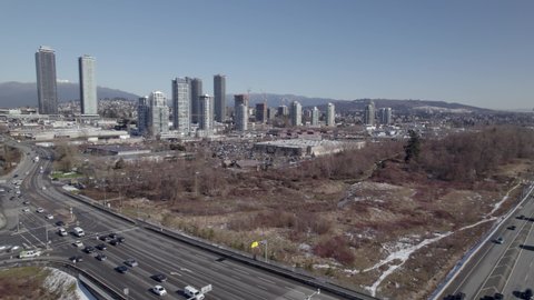 Burnaby city skyscrapers and industrial area, Lower Mainland region of British Columbia, Canada. Aerial drone view