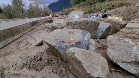 Popkum , British Columbia , Canada - 11 23 2021: Workers doing repair jobs after BC floods near a road