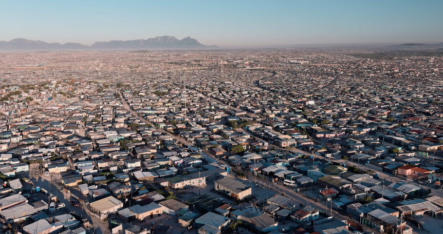 Poverty.Inequality.Aerial fly over view of the densely populated Khayelitsha township on the Cape Flats, Cape Town, South Africa Royalty-Free Stock Footage #1088094767