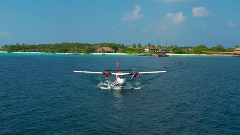 Front view on Seaplane taking off in a tropical island in Maldives.