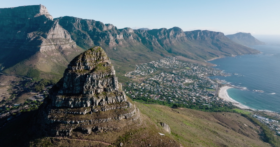 Spectacular aerial view of Table Mountain,Lion's Head mountain, The 12 Apostles mountain range,looking at Camps Bay, Bakoven, Llandudno, Cape Town, South Africa Royalty-Free Stock Footage #1088095983