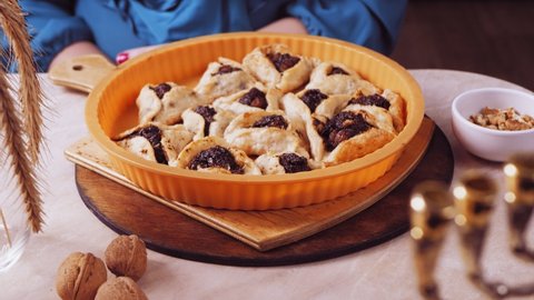 Purim cookies with poppy-seed filling triangular gomentashi on the table in a baking dish