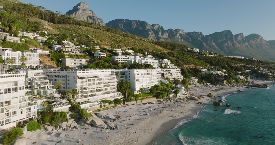 Epic aerial close-up panning view of Clifton beaches,Lion's Head and 12 Apostles mountain range in background,Cape Town, South Africa, travel, tourism  Royalty-Free Stock Footage #1088096043