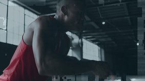 Animation of fight text over african american sportsman at gym. global sports, healthy lifestyle and digital interface concept digitally generated video.