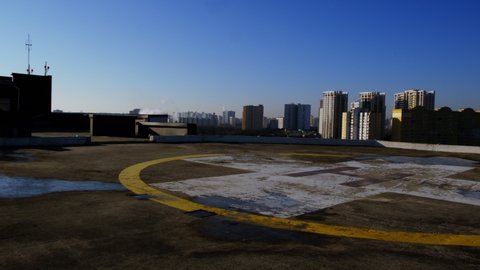 View of the helipad on the roof of a building in the city.