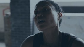 Animation of interference over african american sportswoman at gym. global sports, healthy lifestyle and digital interface concept digitally generated video.