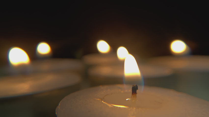 Close view of extinguishing candles. Macro view of several candles going out in the dark. | Shutterstock HD Video #1088098839