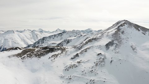 Snow mountain range landscape on winter sunny day. Beautiful panorama of European Alps video from drone. 4k aerial footage of panoramic view of snowy mountains at alpine ski resort in Livigno, Italy 