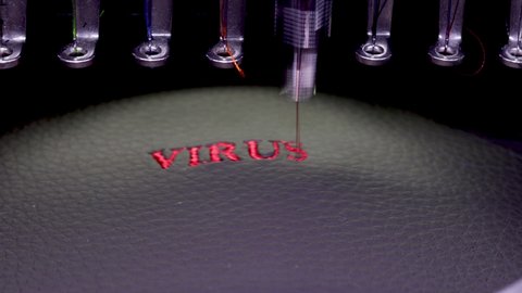 Machine embroidery of the inscription virus on black leather with red thread. Machine embroidery design, close up 4k video.