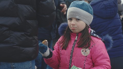Lviv, Ukraine - March 15, 2022: Portrait of little girl refugee from Ukraine standing at the railway station. War at Ukraine concept. Editorial Stock Footage