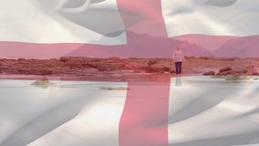 Animation of flag of england over senior caucasian woman on beach. senior lifestyle, retirement and holiday concept digitally generated video.