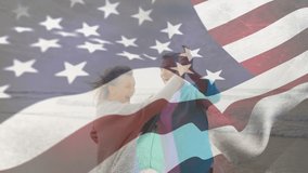 Animation of flag of united states of america over happy senior caucasian couple dancing on beach. senior lifestyle, retirement and holiday concept digitally generated video.
