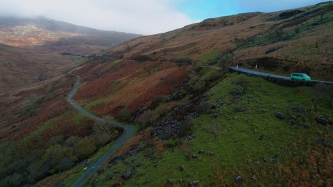 Car driving along road on Pen-y-Pass mountain in Snowdonia, Gwynedd in north-west Wales, Uk. Aerial forward